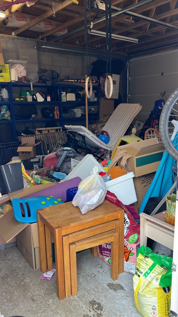 Messy garage piled up with our belongings on the day of filming