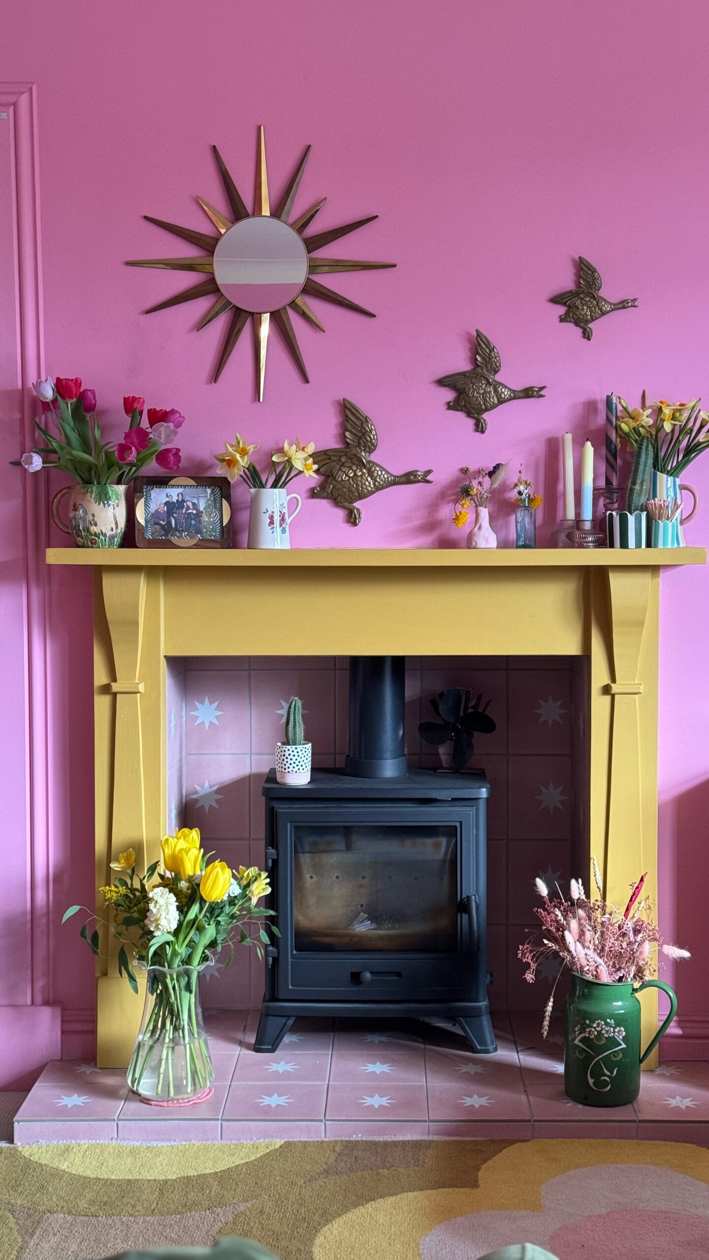 Pink walls with Yellow mantlepiece. Pink tiled hearth